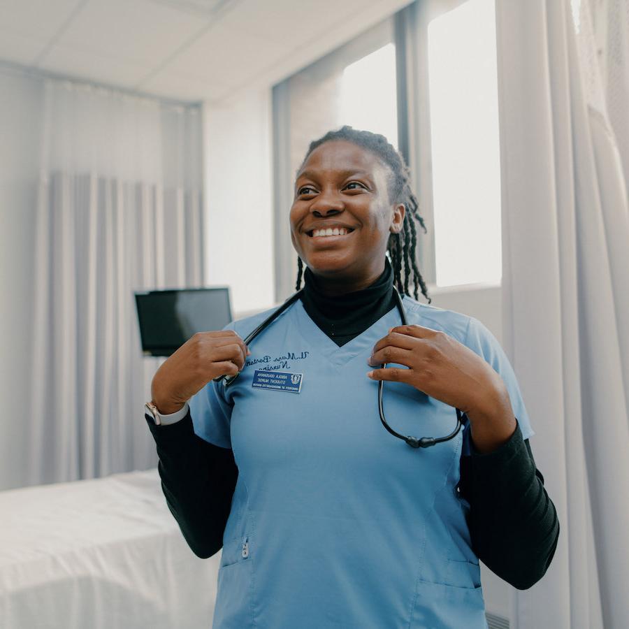 Nursing student smiling in lab